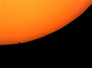 Mercury is about to slip off the visible disk of the sun. 
